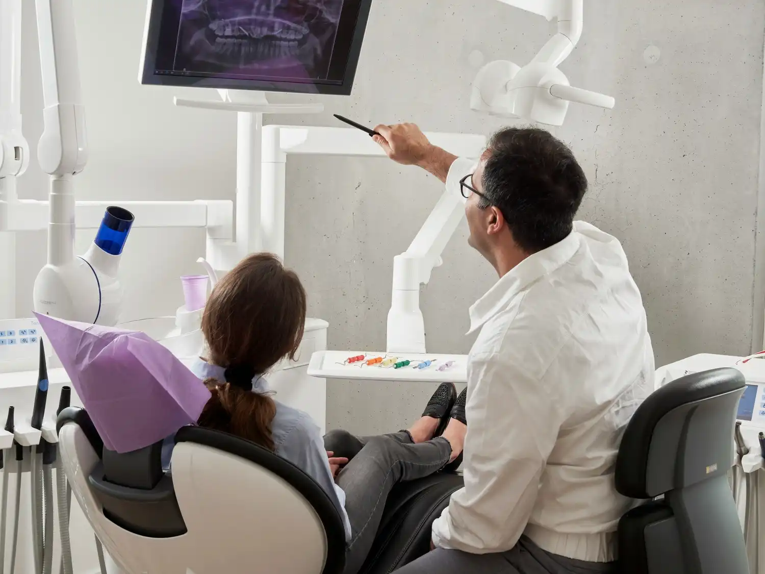 Professional dentist with patient in clinic